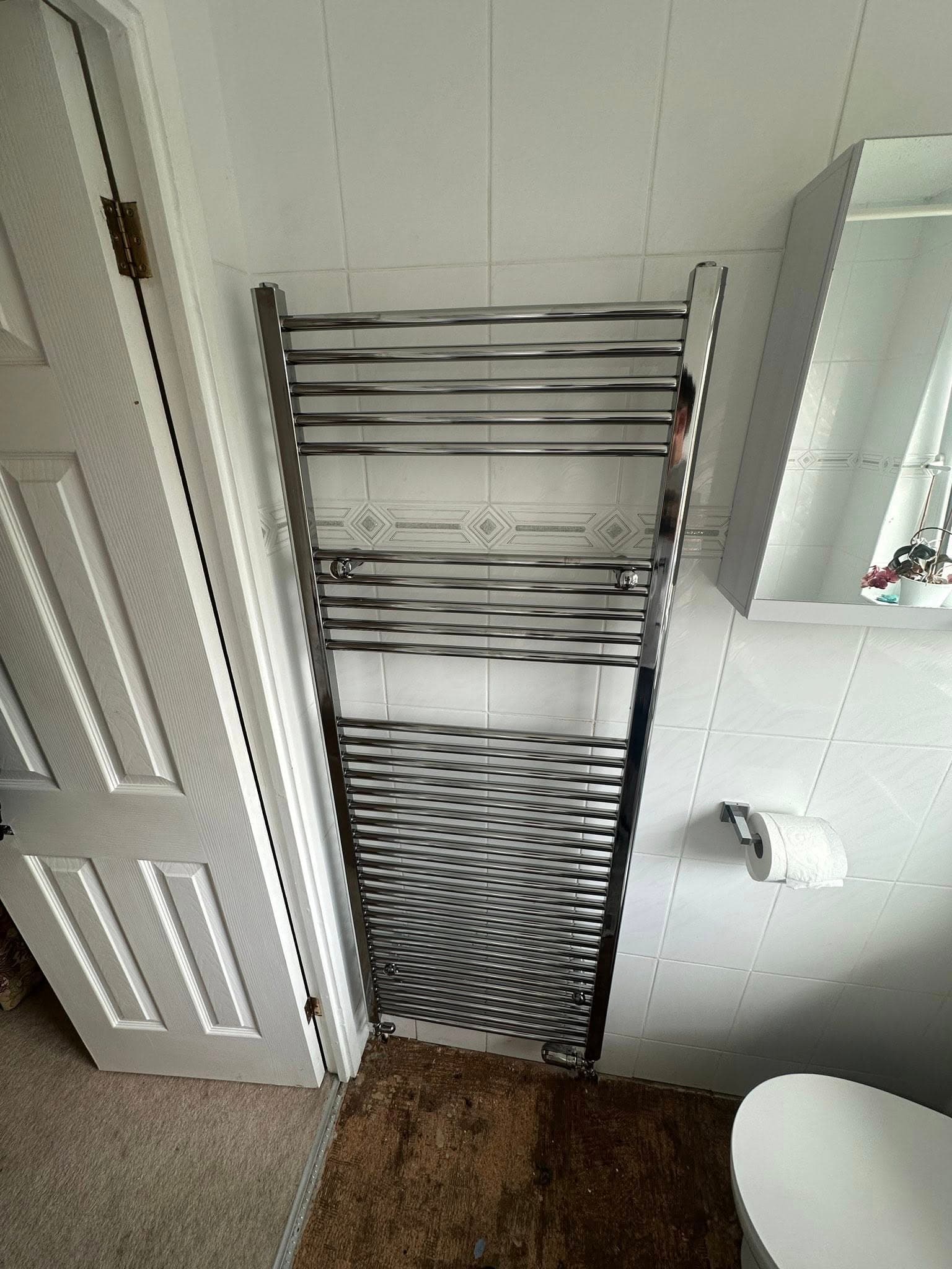 Modern heated towel rack and radiator installation